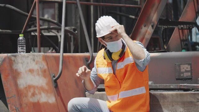 Engineer or construction worker wear safety equipment in the workplace, such as Hardhat, mask, headphone to prevent accident in the industry. Face mask Dust and Coronavirus
