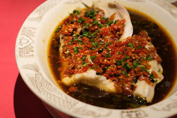 close up Steamed fish head with chopped peppers. Famous Chinese food. Hunan cuisine 