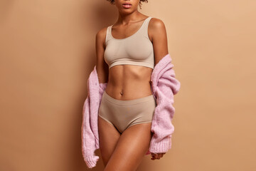 Unrecognizable slim young woman in lingerie has slim figure healthy skin perfect body shape poses...