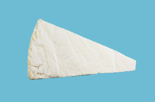 Piece of brie cheese Isolated on blue background. View from above.