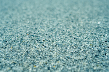  Tiny gravel texture on blue light concrete wall. Texture background seamless gravel floor. Selective focus. Macro close up
