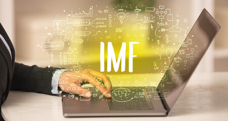 hand working on new modern computer with IMF abbreviation, modern technology concept
