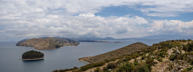 Panorama landscape of island with an amazing cloudy blue sky during summer in isla de la luna, isla del sol, moon island, sund island in lake titicaca, bolivia