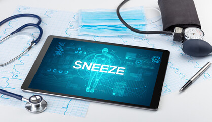 Tablet pc and doctor tools with SNEEZE inscription, coronavirus concept