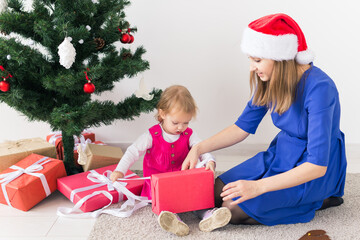 holidays, presents, christmas, xmas concept - happy mother and child girl with gift box