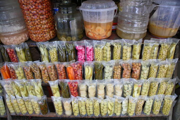 Kerala traditional style pickled and salted fruits and vegetables (Indian: uppilittathu)  in plastic bags and jars for sale in Kerala, India,