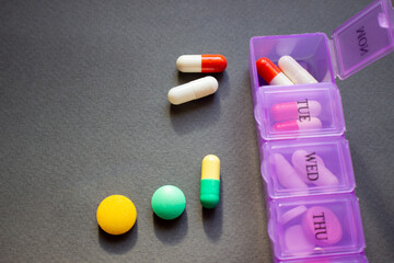 Daily box of pills with medicines, tablets, capsules and food additives.