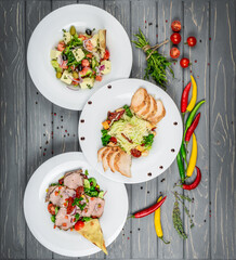 Food. Set of dishes salads on the table. On a wooden background.