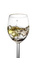 Splashes of white sparkling wine in a glass on a white isolated background.