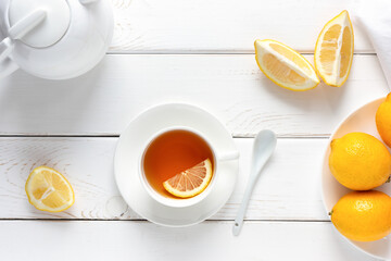 Vitamin, healthy tea with lemon on a white wooden table. Alternative medicine concept