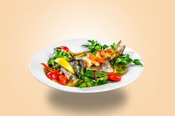 The head of the fish, mussels, greens and prawns are on a white plate. Restaurant service