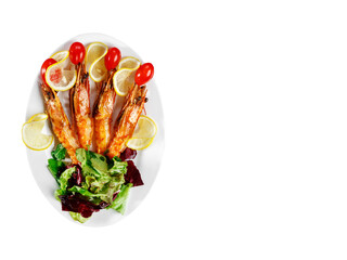 The head of the fish, mussels, greens and prawns are on a white plate.