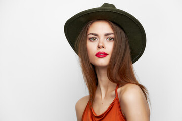 Fototapeta na wymiar attractive woman red lips green hat look forward close-up 