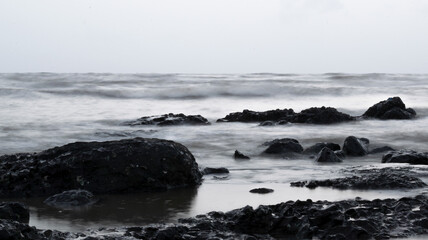 Rocks on beach in evening of mumbai india.