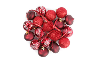a pile of red and white Christmas tree ornaments isolated on white
