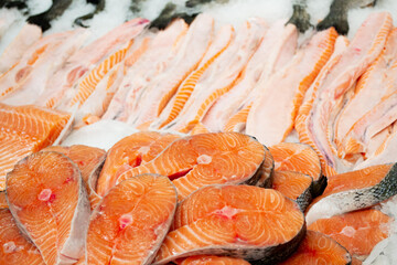 Close up chilled fish steaks and slices of salmon and trout on ice