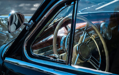 Steering wheel of an old classic car.
Interior of a vintage car.
Color image of the dashboard of a...