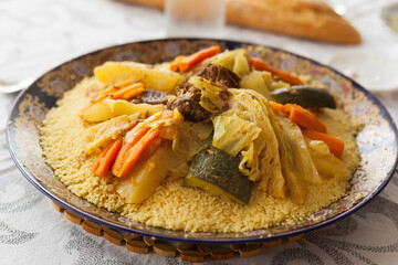 Couscous is a delicious Maghrebi dish of small steamed balls of crushed durum wheat semolina, usually served with a stew spooned on top,meat and vegetables like cauliflower, carrots, leek and laban.