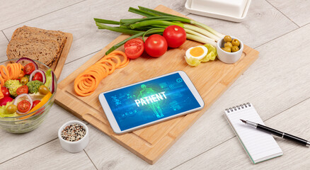 PATIENT concept in tablet with fruits, top view