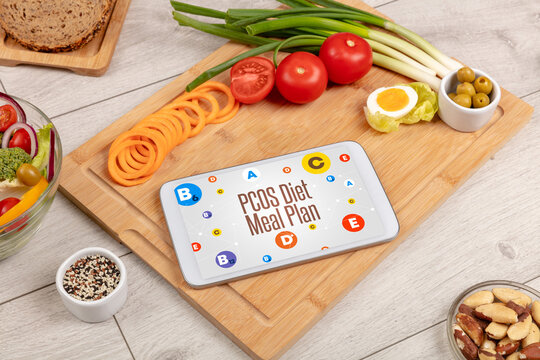 Healthy Tablet Pc compostion with PCOS Diet Meal Plan inscription, weight loss concept