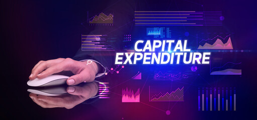hand holding wireless peripheral with CAPITAL EXPENDITURE inscription, cyber business concept
