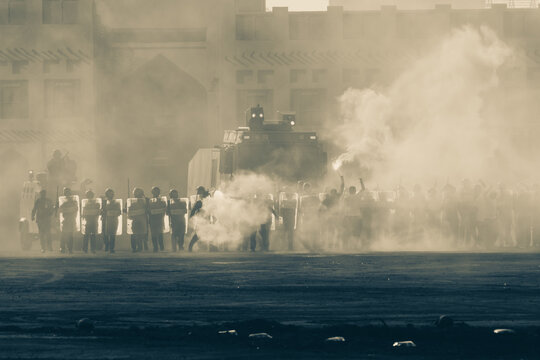 Military Police Riot Response To A Protest With Tear Gas, Smoke, Fire, Explosions. Political Expression, Riot, Protest, Demostration And Military Concept.