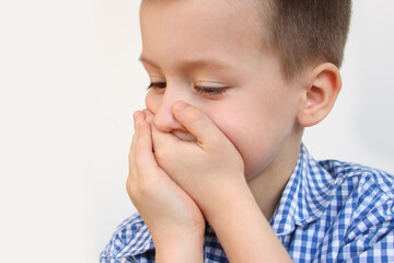 crying child, kid, covering his mouth with fear, shame or resentment, cry and afraid, concept of abuse, outsider in the children&rsquo;s team, bullying, family violence