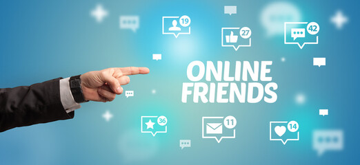 Close-Up of cropped hand pointing at ONLINE FRIENDS inscription, social networking concept