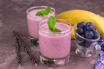 Healthy banana blueberry smoothie in glasses.
Close-up.