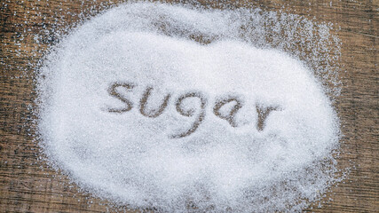 Inscription sugar made into pile of white granulated sugar.