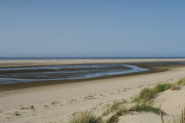 Blick vom D&uuml;nen&uuml;berweg auf den Strand von Langeoog im Sommer. Bei Niedrigwasser sind der teils trockengefallene Priel und die Sandbank in der Nordsee gut zu erkennen.  