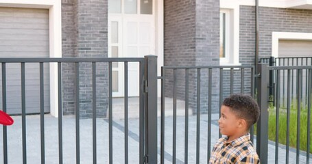 African American parents playing frisbee with small cute son outdoor at house in suburb. Happy joyful family play game at street in summer. Mother, father and little boy having fun on weekend. - Powered by Adobe