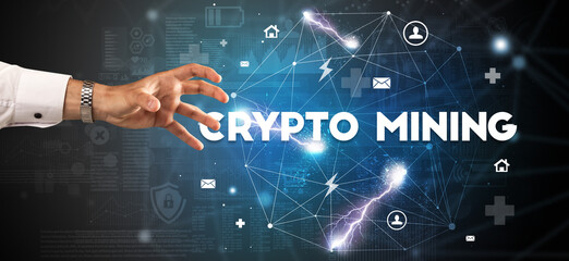 Hand pointing at CRYPTO MINING inscription, modern technology concept