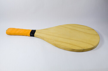 Beach tennis racket and ball with white background