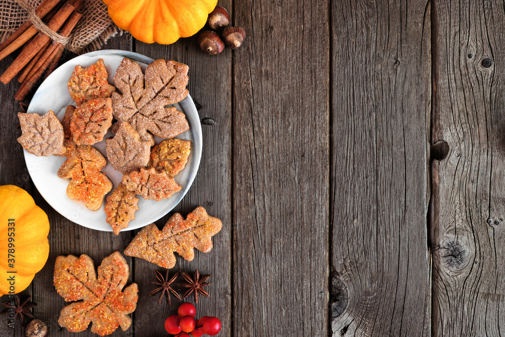 Aufkleber Autumn leaf sugar cookies. Top view side border on a rustic wood background with copy space.