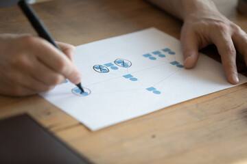 Close up of CEO or boss sit at desk brainstorm work on company business project. Male HR or...