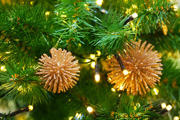 New year holiday or christmas green background. Branches of christmas trees decorated with chic golden decorations, garlands and toys, xmas. New Year concept