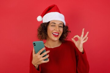 Portrait of a pretty happy Caucasian girl taking a selfie isolated over bright background