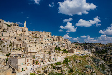 Obraz premium Matera, Basilicata, Italy - Panoramic view from the top of the Sassi of Matera, Barisano and Caveoso. The ancient houses of stone and brick, carved into the rock. The ravine in the background.