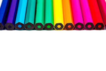 colored pencils of different colors on a white background