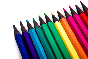 colored pencils of different colors on a white background