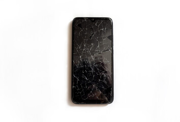 A modern mobile black touch smartphone with a broken glass screen isolated on a white background. Service, repair and technological concept. Copy space for text