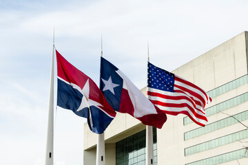 Flags of Dallas, Texas and US on the wind