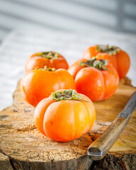 still life with persimmons. vertical image. selective focus