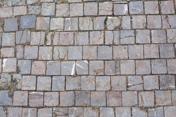 Texture of old broken stone paving stones