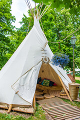 A tent in a summer cafe in a green park. Themed hipster cafe in the city park