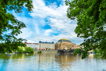 Obraz premium View of the National Theater Building in Prague from the Vltava River. Architecture of Europe
