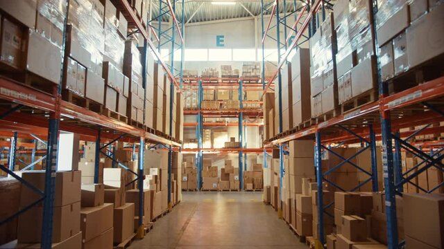 Retail Warehouse full of Shelves with Goods in Cardboard Boxes and Packages. Logistics, Sorting and Distribution Facility for Product Delivery. Descending Static Camera View Between Rows of Shelves