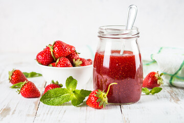 Strawberry jam in the glass jar.