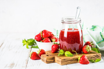 Strawberry jam in the glass jar.